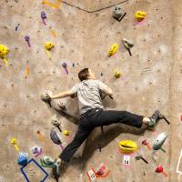 competitor stemming between walls and contemplating their next big reach